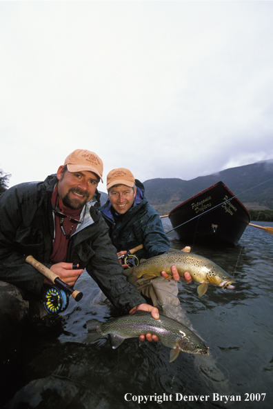 Flyfishermen holding trout.