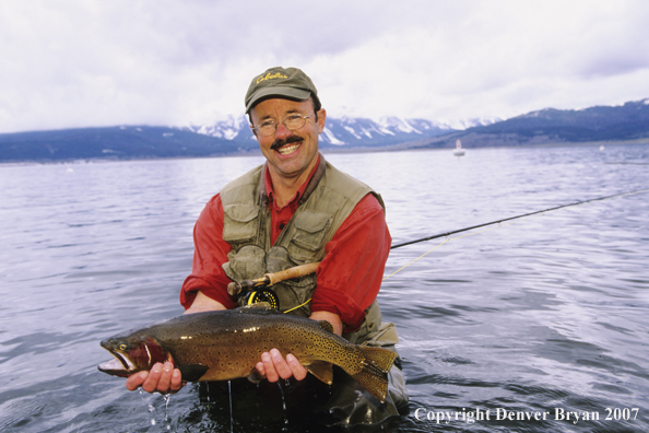 Flyfisherman with large cutthroat trout.