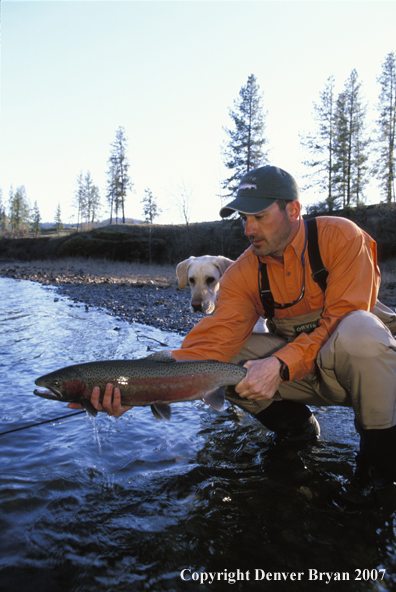 Flyfisherman holding steelhead.