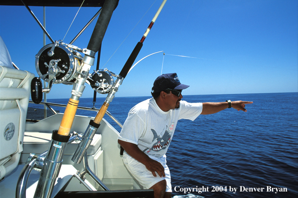 Fishing guide pointing at fish