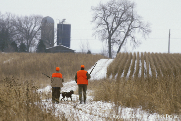 Father and son pheasant hunting.