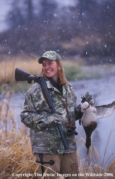 Female waterfowl hunter with bagged duck.