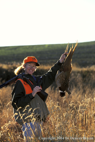 Upland game bird hunter with bagged pheasant.