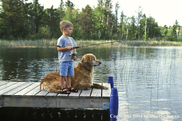 Golden Retriever with young child fishing.