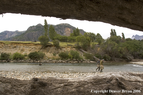 Flyfishermen walking up river.