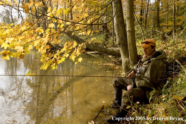 Flyfisherman checking out small stream before fishing.