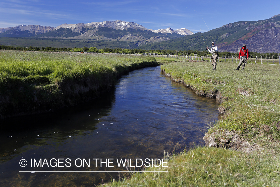 Flyfisherman casting line on stream.