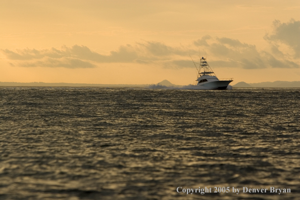 Deep sea fishing charter boat on ocean.