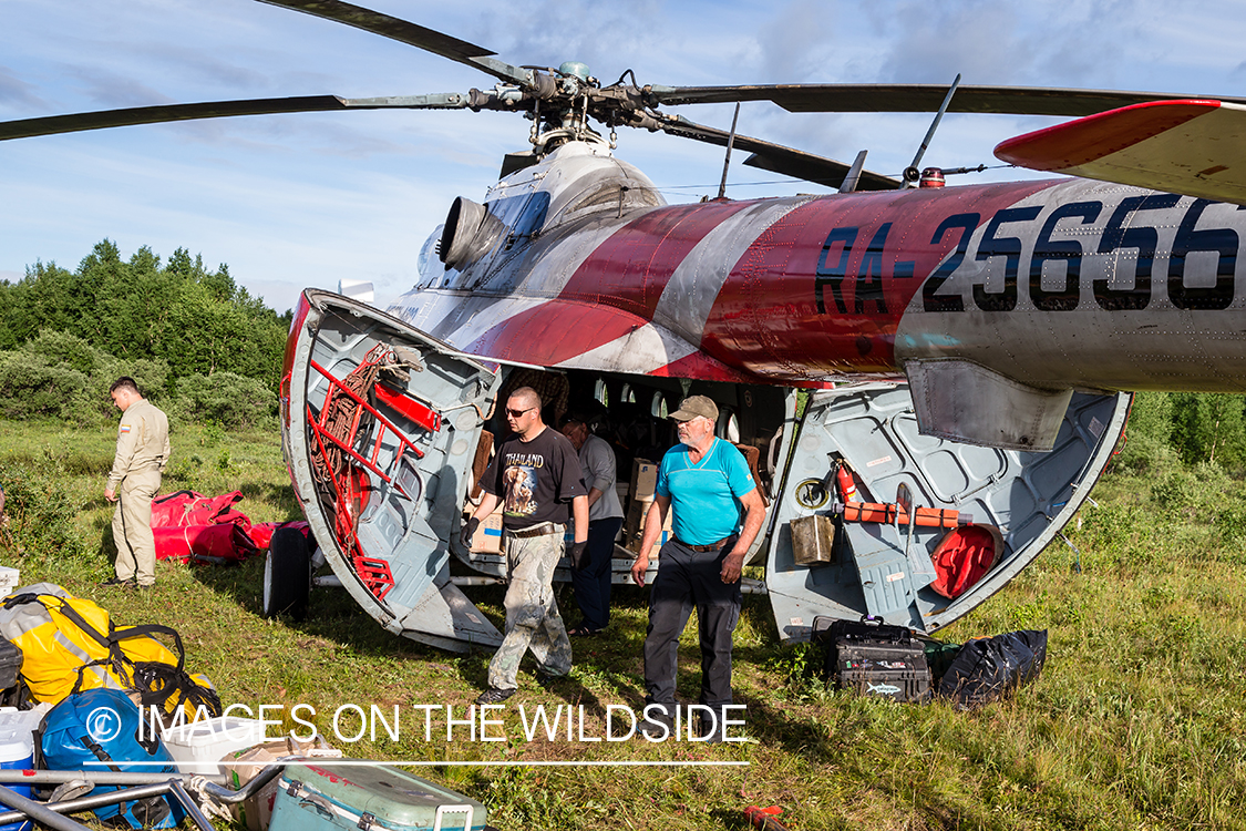 Loading gear into Russian helicopter in Kamchatka Peninsula, Russia. 