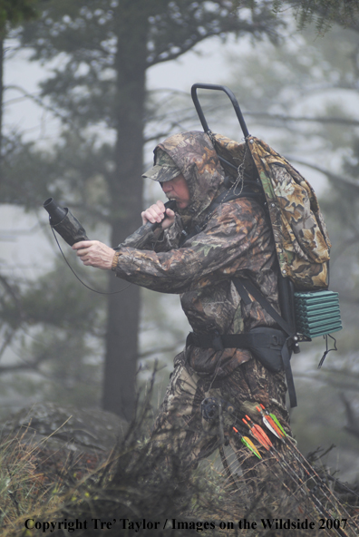 Bowhunter bugling for elk