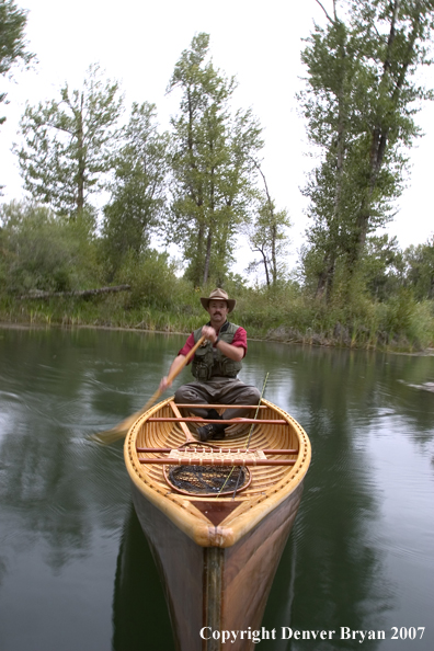 Man canoeing on pond (MR).