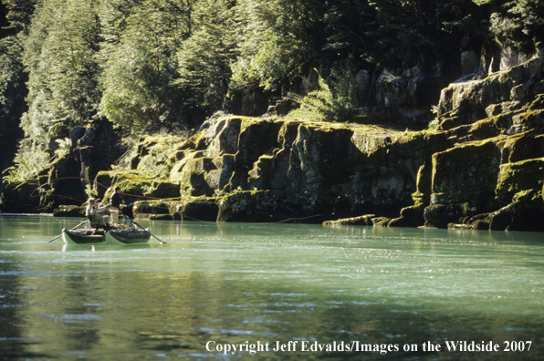 Guide and anglers drifting and fishing in canyon