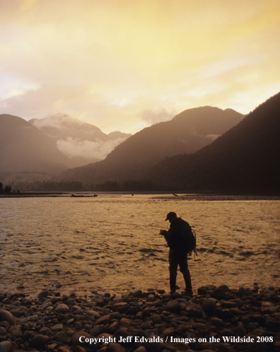 Angler fishing at last light