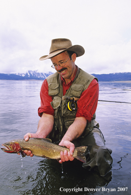 Flyfisherman with large cutthroat trout.