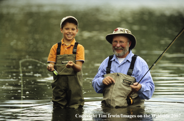 Grandfather teaching grandson how to fish