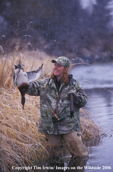 Female waterfowl hunter with bagged duck.