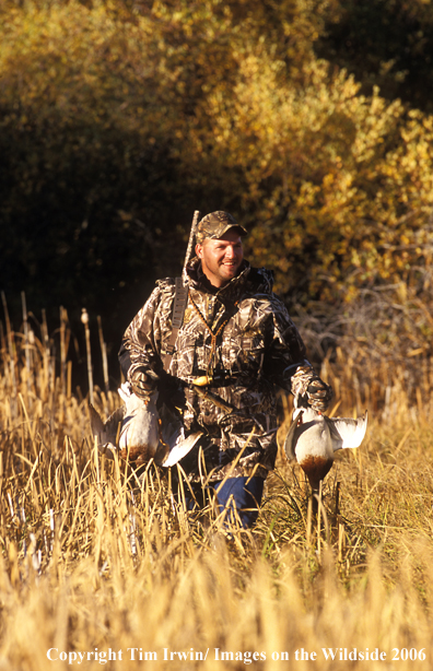 Waterfowl hunter with bagged ducks.