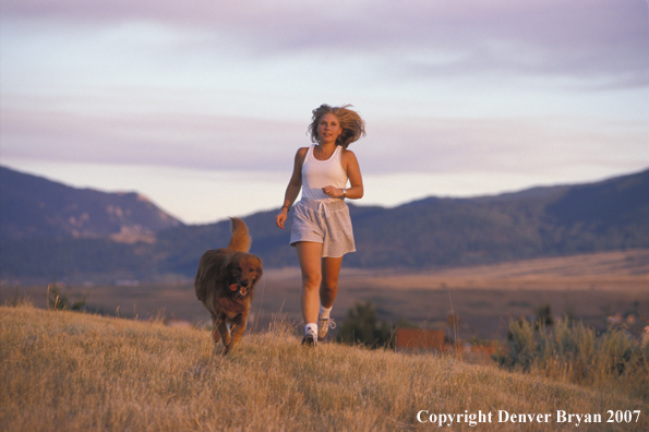 Woman running with golden Retriever