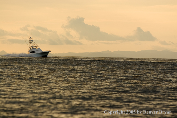 Deep sea fishing charter boat on ocean.