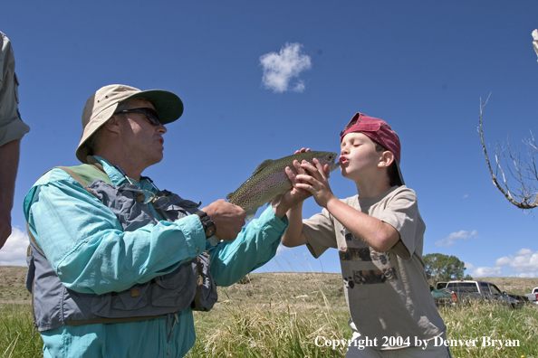 Father and son with rainbow trout