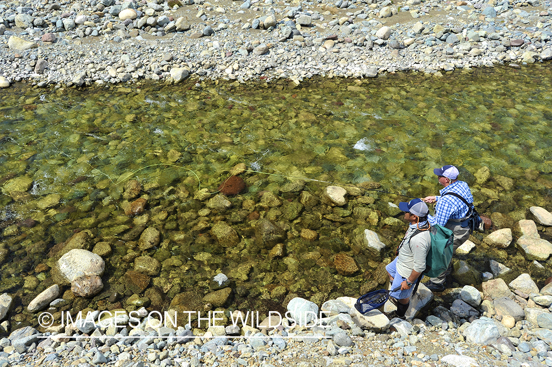 Fishermen on river.