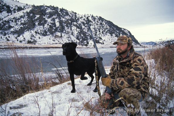 Duck hunter with black Lab.