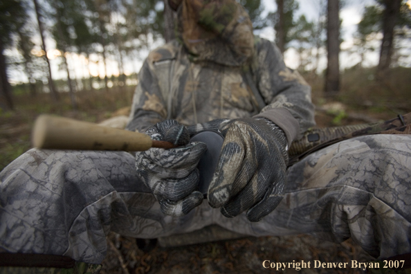 Turkey hunter calling in the field