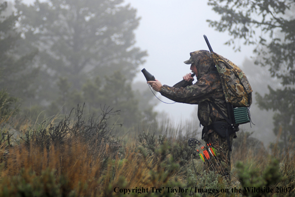 Bowhunter bugling for elk