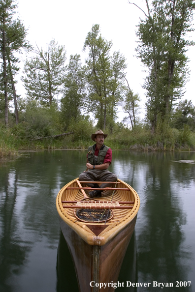 Man canoeing on pond (MR).