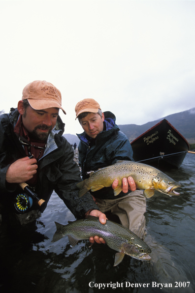 Flyfishermen holding trout.