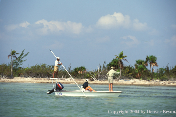 Saltwater flyfishermen and guide fishing from boat.