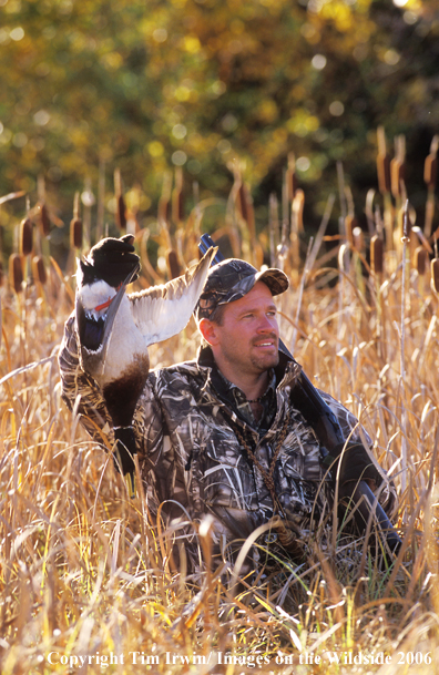 Waterfowl hunter with bagged duck.