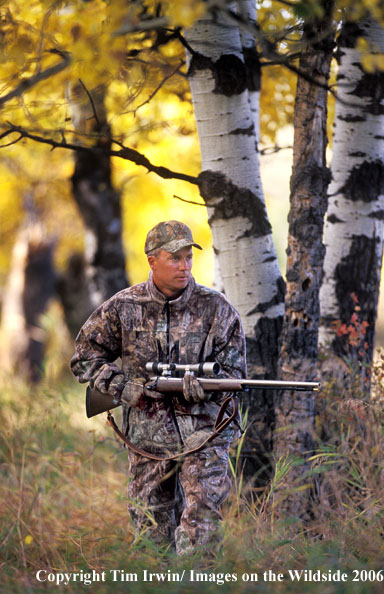 In-line muzzleloader hunter in field.