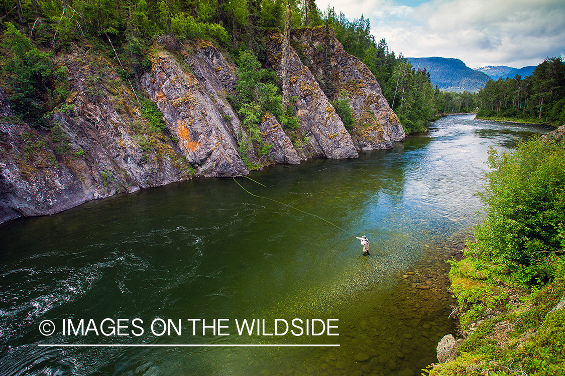 Flyfisherman spey casting on Nakina River, British Columbia.