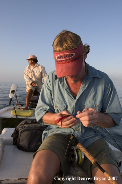 Saltwater flyfisherman tying fly on 