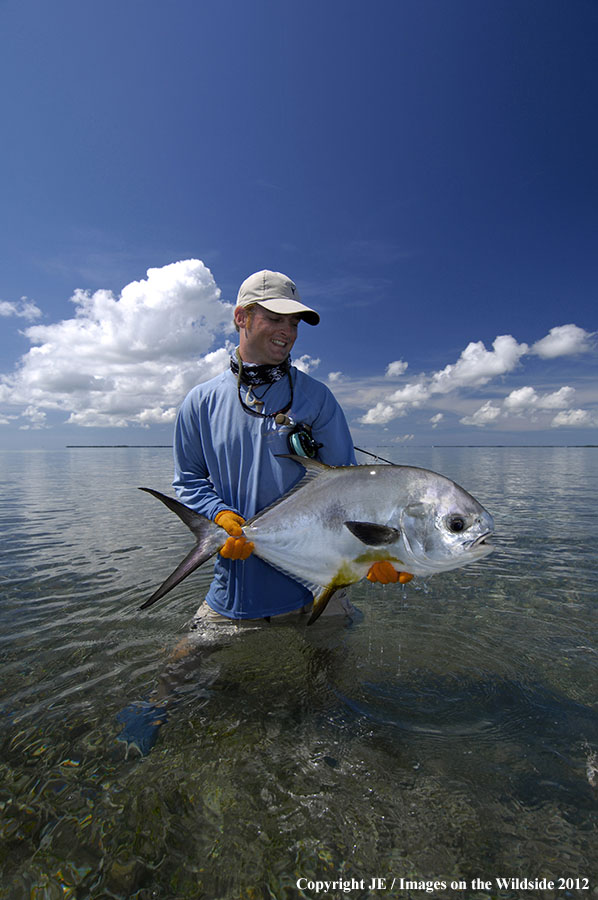 Flyfisherman holding permit catch.