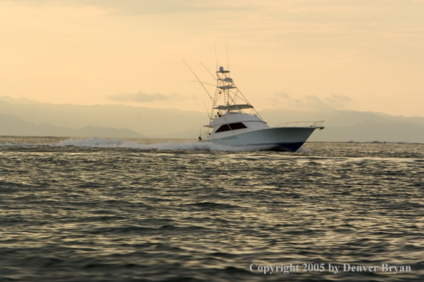 Deep sea fishing charter boat on ocean.