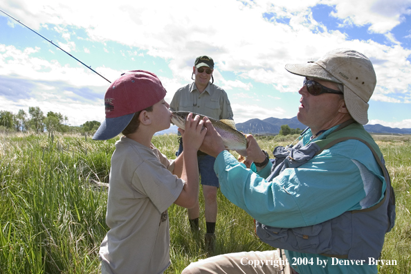 Father and son with rainbow trout.