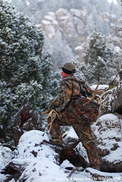 Hunter Collecting Antlers