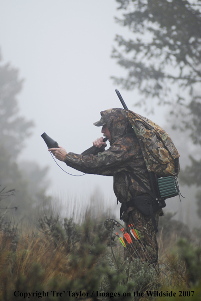 Bowhunter bugling for elk