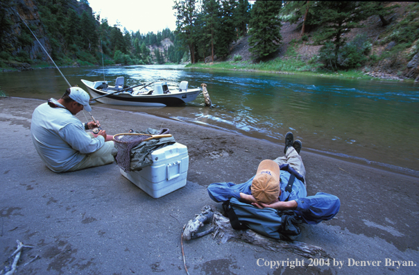 Flyfishermen taking a break on shore.