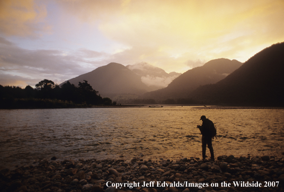 Angler fishing at last light