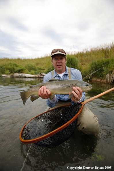 Flyfisherman with brown trout