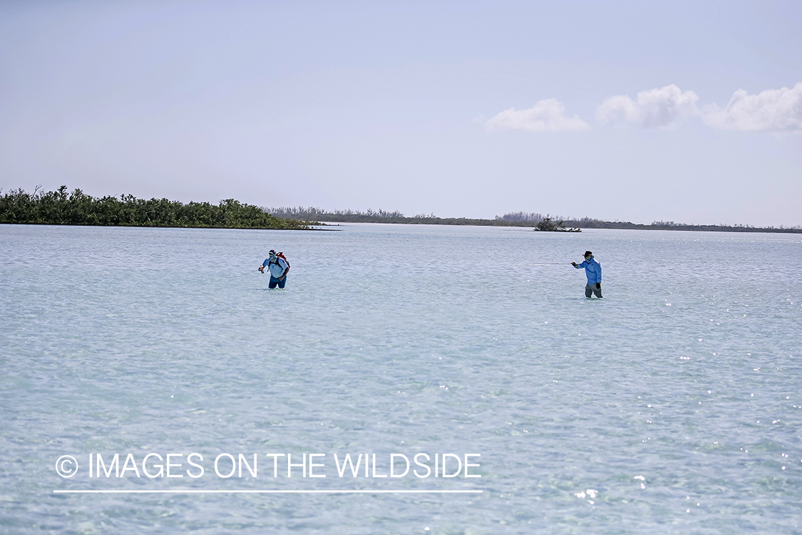 Flyfishermen on beach.