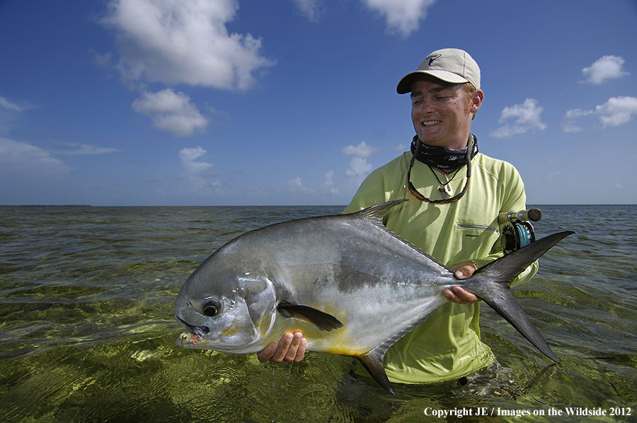 Flyfisherman holding permit catch.