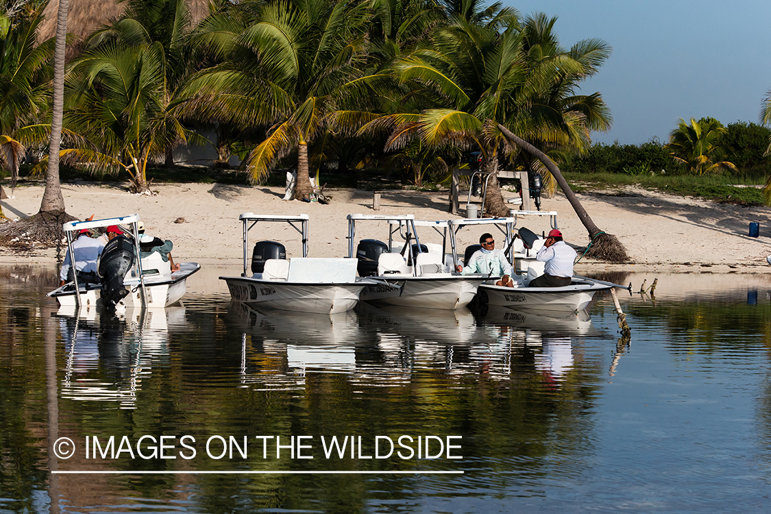 Flyfishermen relaxing on flats boats.