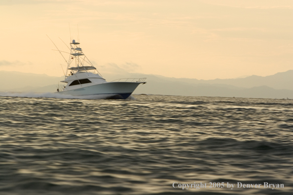 Deep sea fishing charter boat on ocean.