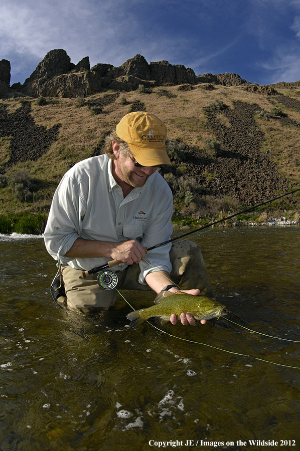 Fisherman with smallmouth bass.