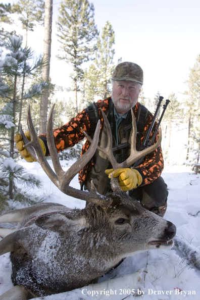 Mule deer hunter with downed buck.