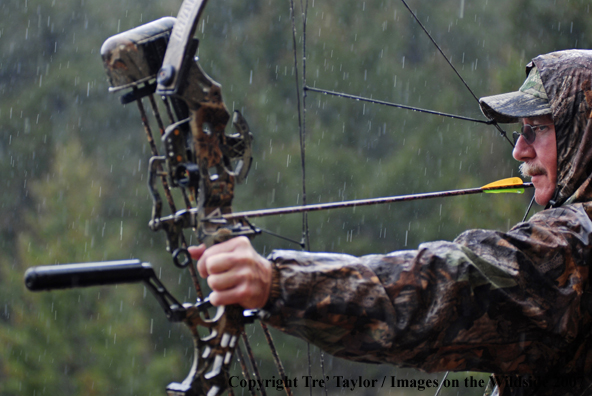 Bowhunter drawing back bow